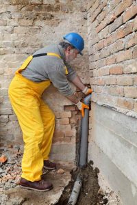 a plumber repairing the pipes a plumber repairing the pipes